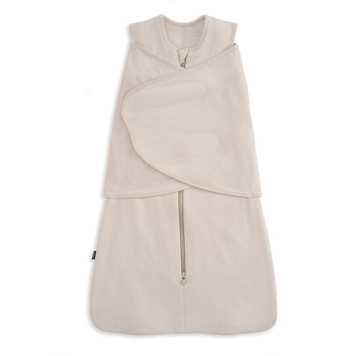 The HALO SuperSoft Bamboo Swaddle TOG 2.0 in beige is a sleeveless swaddle made from soft bamboo, featuring a front zipper and adjustable Velcro wings for secure swaddling.