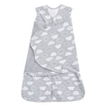 The HALO Swaddle 100% Cotton TOG 1.5 is a gray sleep sack with white clouds, featuring adjustable wings, a front zipper, wrap-around flap, and Velcro closures for easy swaddling while promoting healthy hip development.