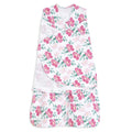 The HALO Swaddle 100% Cotton TOG 1.5 has a sleeveless design with adjustable wings and features a floral pattern of pink flowers and green leaves on white, promoting healthy hip development.