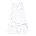 The HALO Swaddle 100% Cotton TOG 1.5 is a white infant sleep sack with a pink and gray star pattern, adjustable wings, sleeveless design, Velcro wrap, and front zipper for healthy hip development and a cozy sleeping environment.