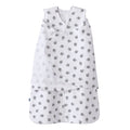 The HALO Swaddle 100% Cotton TOG 1.5 in white features gray turtle patterns, a sleeveless design, and overlapping chest fabric for an adjustable fit, shown on a plain background.