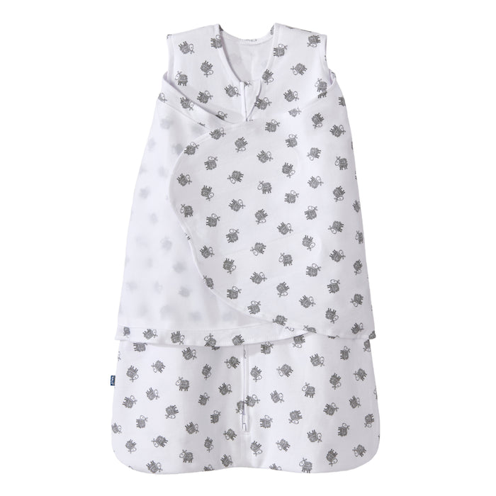 The HALO Swaddle 100% Cotton TOG 1.5 in white features gray turtle patterns, a sleeveless design, and overlapping chest fabric for an adjustable fit, shown on a plain background.