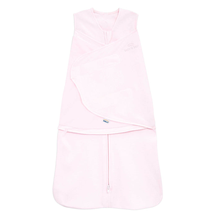 The HALO Swaddle 100% Cotton TOG 1.5 is a soft pink sleeveless baby wearable blanket, with adjustable fasteners and a bottom zipper for easy access, featuring a versatile 3-in-1 design for comfort.