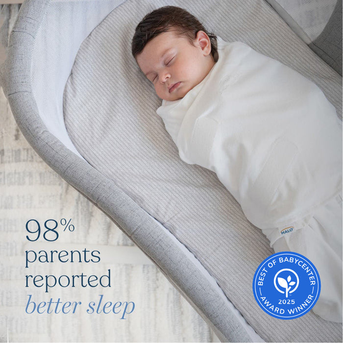 A baby in a HALO Eric Carle The Very Hungry Caterpillar 100% Cotton Swaddle TOG 1.5 sleeps peacefully in a gray bassinet. Text: 98% of parents reported better sleep. A blue badge reads, Best of BabyCenter Award Winner 2025.