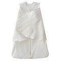 The HALO Swaddle 100% Organic Cotton TOG 1.5 is white with a zipper, adjustable Velcro wraps, and wings for healthy hip development. It has a sleeveless design and front embroidery.