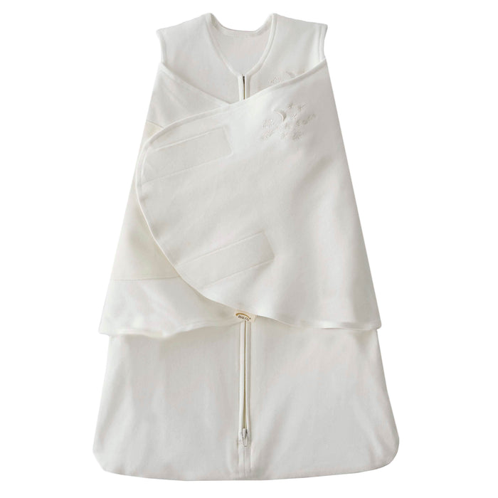 The HALO Swaddle 100% Organic Cotton TOG 1.5 is white with a zipper, adjustable Velcro wraps, and wings for healthy hip development. It has a sleeveless design and front embroidery.