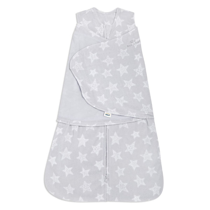 The HALO Swaddle Micro-Fleece TOG 3.0, a gray wearable baby blanket with white stars, features adjustable wings and a front zipper. Its sleeveless design ensures healthy hip development while providing a soft, snug fit to keep your baby warm and secure.