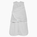 The HALO Swaddle Micro-Fleece TOG 3.0 in light gray, featuring adjustable swaddle wings, a bottom zipper, and soft fleece texture, is shown against a white background.