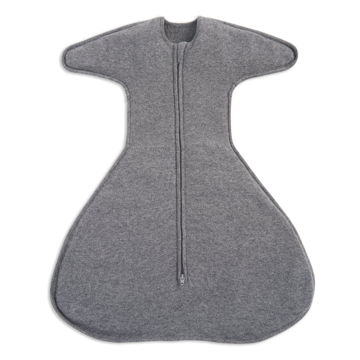 A gray, soft, ergonomic HALO SwaddleStretch™ Newborn Swaddle TOG 0.5 features wide arms, a flared hip-healthy bottom, and a central zipper running from neckline to base.