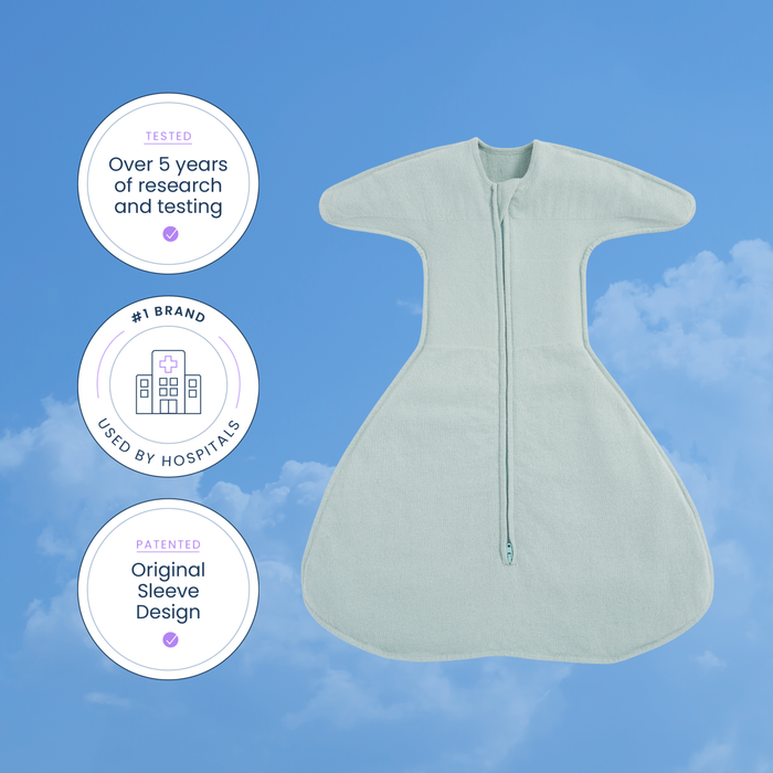 A light blue HALO SwaddleStretch™ Newborn Swaddle TOG 0.5 is displayed against a sky background, accompanied by three circular badges highlighting its research foundation, hospital-trusted use, and patented sleeve design. This hip-healthy swaddle provides comfort and security for your little one.