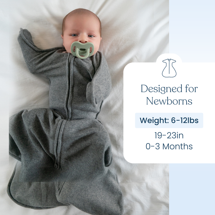 A baby in a gray HALO SwaddleStretch™ Newborn Swaddle TOG 0.5 with a pacifier lies on a white blanket. Text reads: Designed for newborns, hip-healthy sleep swaddle, Weight: 6-12 lbs, Length: 19-23 in, Age: 0-3 months.