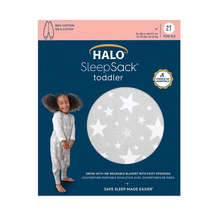 Packaging for a HALO Toddler 100% Cotton TOG 0.5 SleepSack showcases a child in the adjustable gray sleep sack adorned with white stars, featuring convenient foot openings.