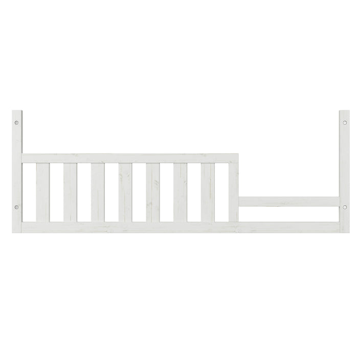 The Child Craft Toddler Guard Rail in White/Brown features vertical slats and an uneven top edge, easily attaching to a toddler bed or crib conversion to add extra safety for your child.