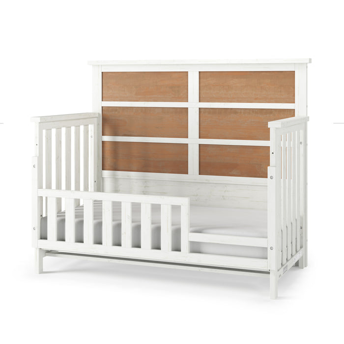 The Child Craft Toddler Guard Rail in White/Brown features four rustic brown panels on a high headboard, vertical slats, and a built-in guard rail for safe, easy crib-to-bed conversion and convenient toddler access.