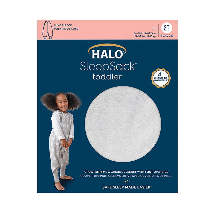 HALOs Toddler Luxe Fleece TOG 2.0 packaging shows a smiling child in pajamas, emphasizing comfy luxe fleece material. The dark blue design highlights its safety with adjustable features for peaceful sleep.