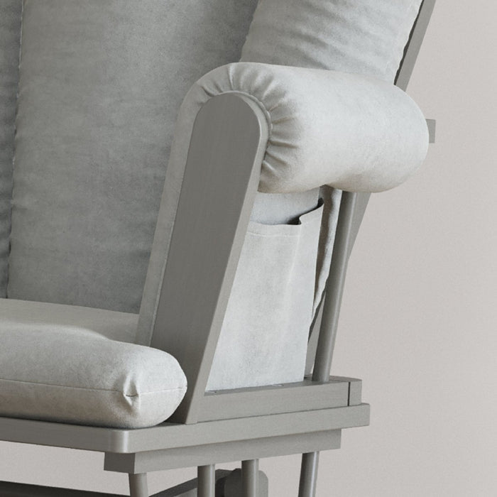 Close-up of the Child Craft Tranquil Nursery Glider Cushion in gray, featuring a wooden frame and built-in side pocket on the armrest. Its soft, plush upholstery offers a cozy, comfortable experience as a baby rocking chair.