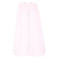 The HALO Wearable Blanket 100% Cotton TOG 0.5 is light pink, sleeveless, with a front zipper and embroidered logo. This blanket ensures safe sleep by keeping babies warm and cozy at night with its soft material.