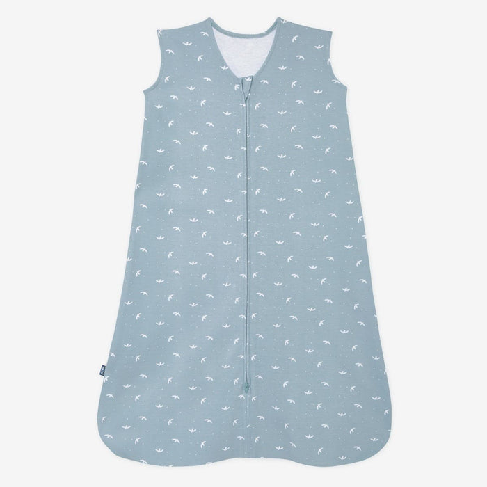 The HALO Wearable Blanket is a sleeveless blue 100% cotton sleep sack with TOG 0.5, featuring a front zipper and small white whale patterns for safe sleep.