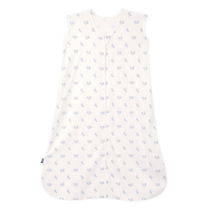 The HALO Wearable Blanket is a 100% cotton, TOG 0.5 sleeveless sleep sack with a front zipper and light background, adorned with a breathable pattern of small blue flowers for safe and stylish sleep.