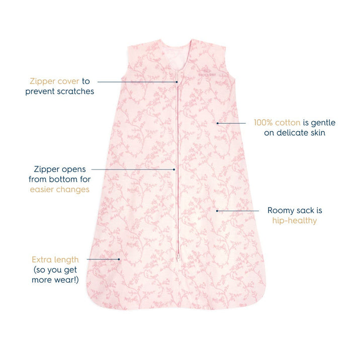 The HALO Wearable Blanket 100% Cotton TOG 0.5, a pink printed design, ensures safe baby sleep with its zipper cover to prevent scratches, bottom-opening zipper, roomy hip area, and extra length for extended use.