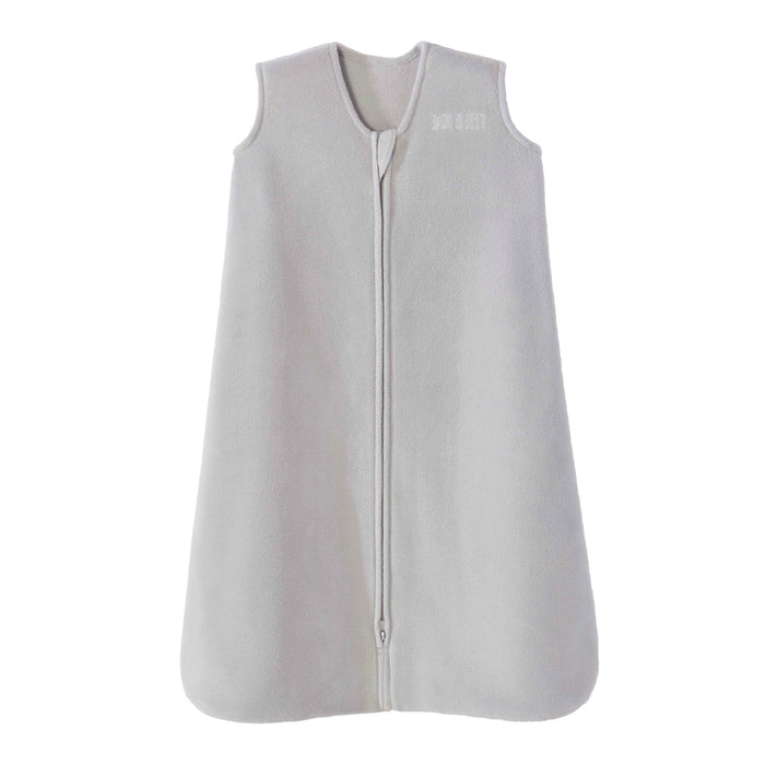 The HALO Wearable Blanket Micro-Fleece TOG 1.0 is a sleeveless, light gray baby sleeping bag crafted from soft microfleece, featuring a front zipper and rounded bottom edges for safe sleep.