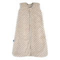 The HALO Wearable Blanket Plushy Dot Velboa TOG 1.5 is a beige, sleeveless sleep sack made of soft fabric with raised dots and a full-length front zipper for safe and comfortable sleep.