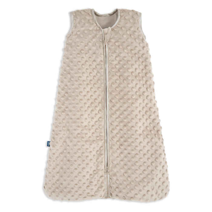 The HALO Wearable Blanket Plushy Dot Velboa TOG 1.5 is a beige, sleeveless sleep sack made of soft fabric with raised dots and a full-length front zipper for safe and comfortable sleep.
