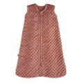 The HALO Wearable Blanket Plushy Dot Velboa TOG 1.5 is a sleeveless, rose-colored baby sleep sack made from soft, textured fabric with raised dots and a front zipper, designed for safe and cozy sleep.