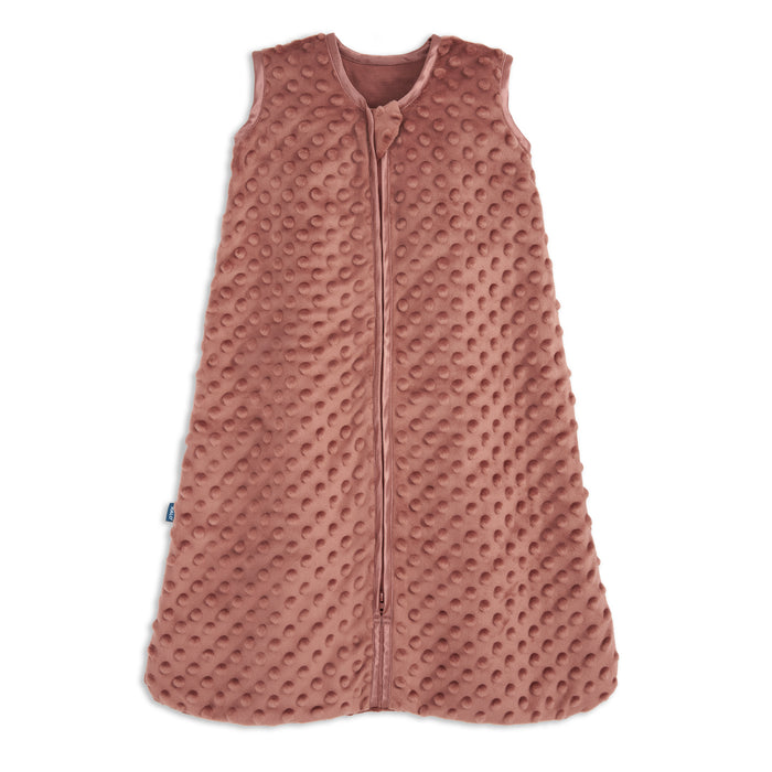 The HALO Wearable Blanket Plushy Dot Velboa TOG 1.5 is a sleeveless, rose-colored baby sleep sack made from soft, textured fabric with raised dots and a front zipper, designed for safe and cozy sleep.